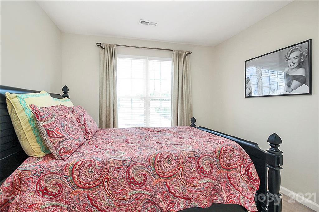 911 Azurine Circle, Unit 74 Fort Mill, SC 29708 - Photo 29 of 40 a bedroom with a large bed and a window