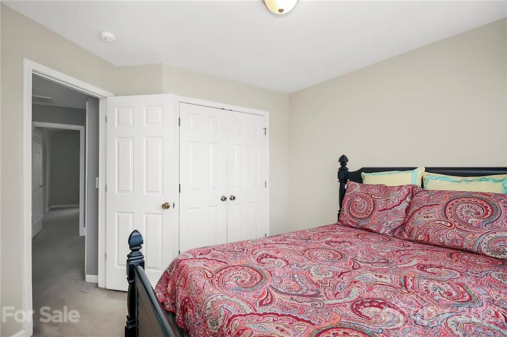 911 Azurine Circle, Unit 74 Fort Mill, SC 29708 - Photo 30 of 40 a bedroom with a large bed and a mirror