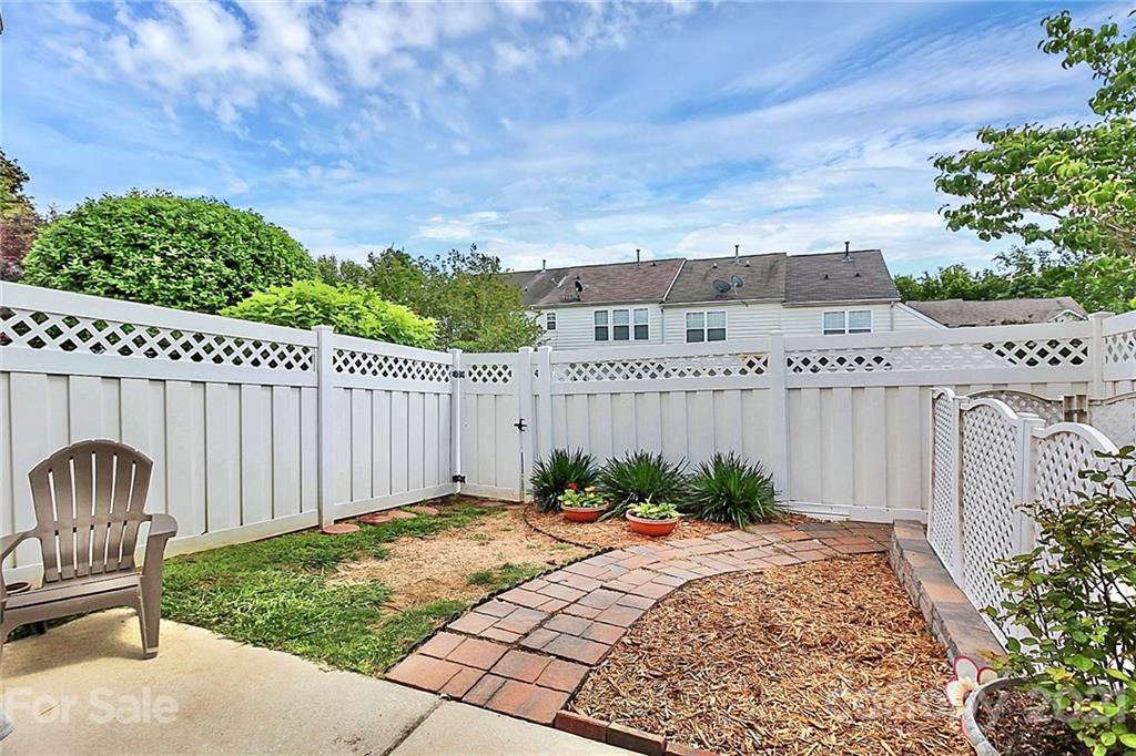 911 Azurine Circle, Unit 74 Fort Mill, SC 29708 - Photo 36 of 40 a view of a backyard with a barbeque and wooden fence