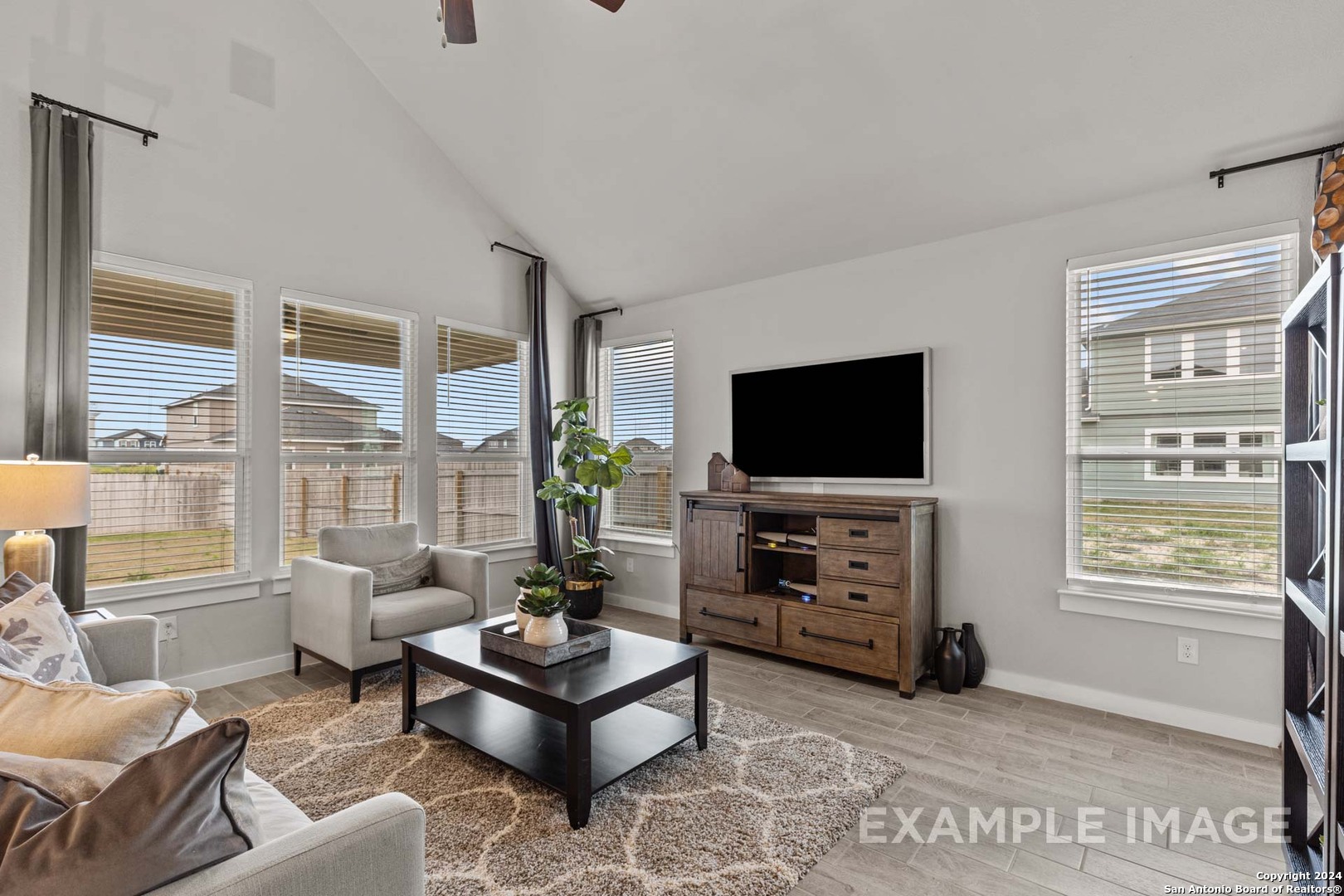401 Tims Way Seguin, TX 78155 - Photo 13 of 50 a living room with furniture a flat screen tv and a large window