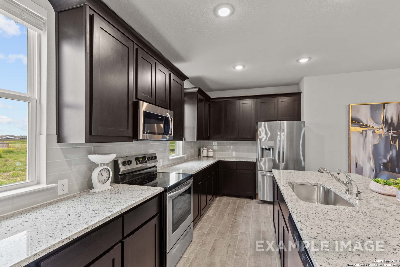 401 Tims Way Seguin, TX 78155 - Photo 25 of 50 a kitchen with stainless steel appliances granite countertop a sink stove and refrigerator