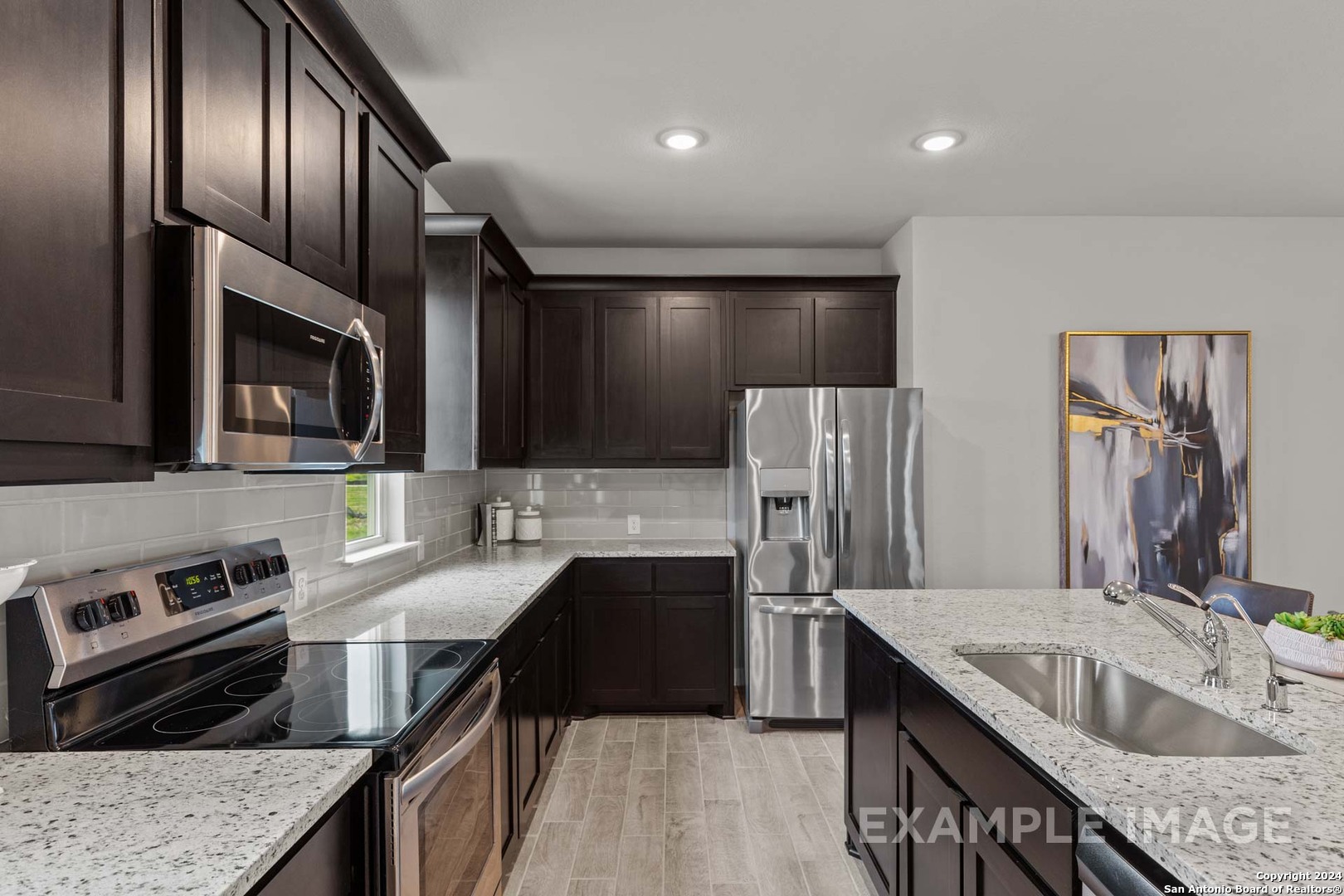 401 Tims Way Seguin, TX 78155 - Photo 26 of 50 a kitchen with stainless steel appliances granite countertop a sink stove and refrigerator