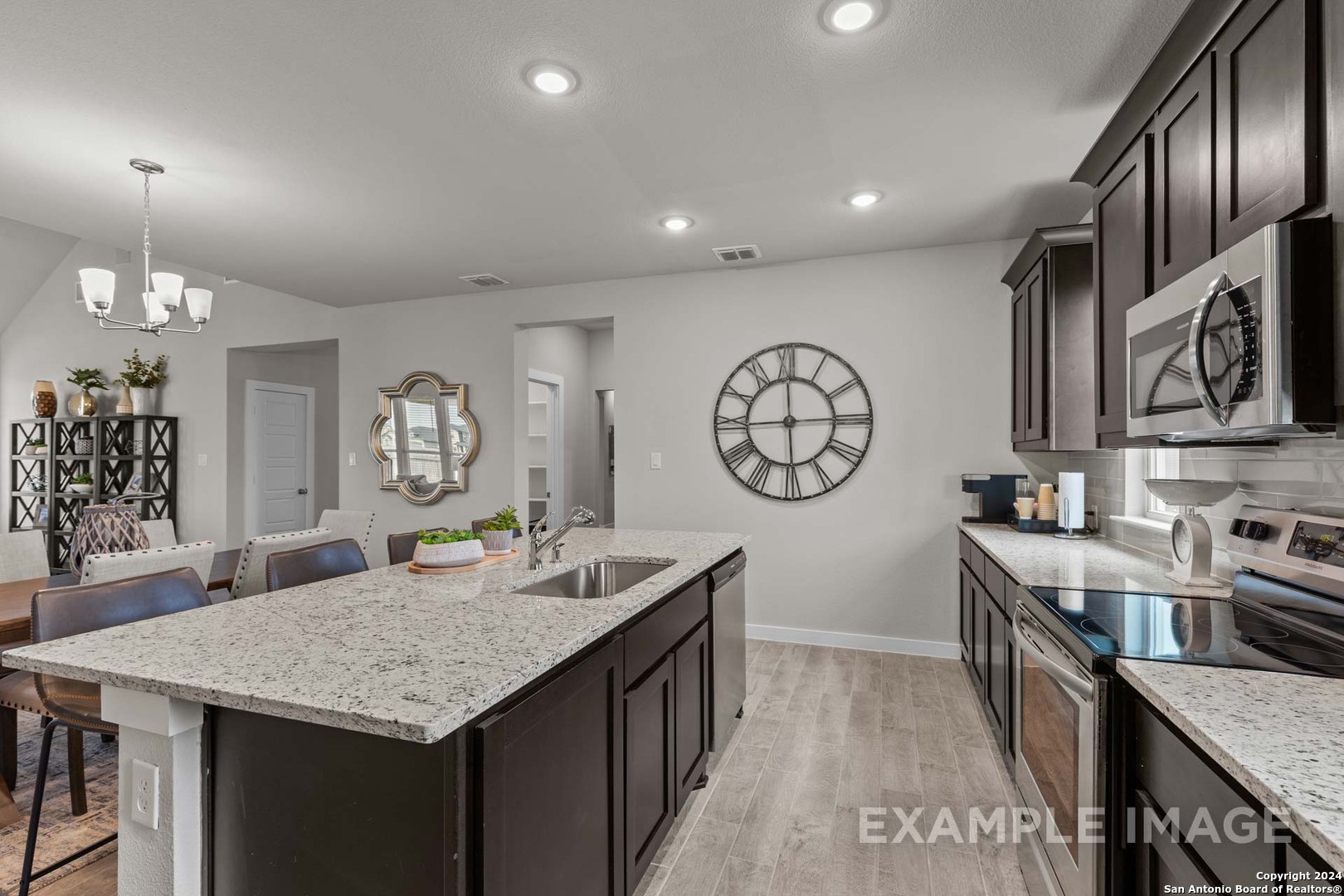 401 Tims Way Seguin, TX 78155 - Photo 27 of 50 a kitchen with stainless steel appliances granite countertop a kitchen island a stove and a sink