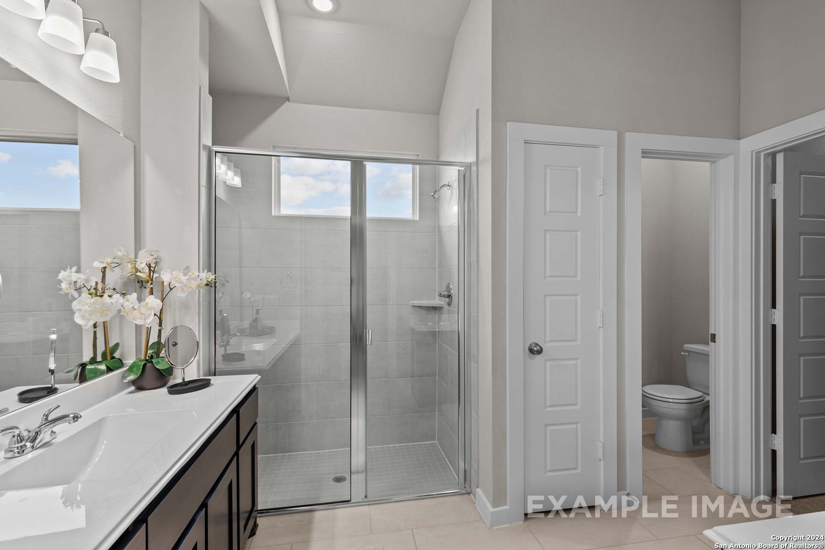 401 Tims Way Seguin, TX 78155 - Photo 34 of 50 a bathroom with a granite countertop sink a mirror and a shower