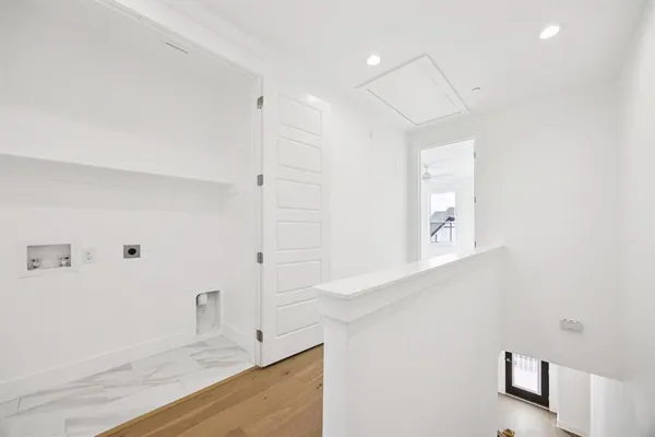 a view of a kitchen with white cabinets