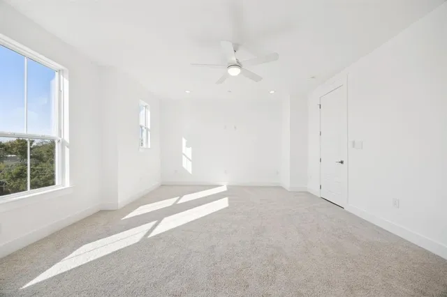 an empty room with windows and closet