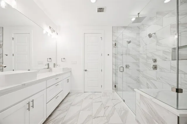 a spacious bathroom with a shower sink vanity and mirror
