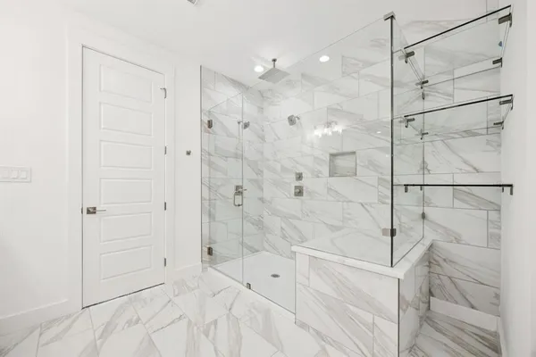a bathroom with a shower and a glass door