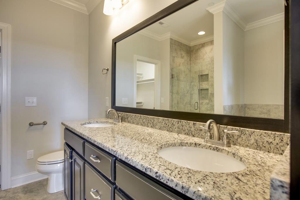 4325 Glassgow Road Spring Hill, TN 37174 - Photo 15 of 28 a bathroom with a granite countertop double vanity sink and a mirror