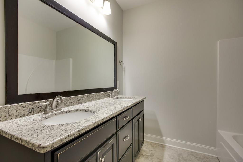 4325 Glassgow Road Spring Hill, TN 37174 - Photo 23 of 28 a bathroom with a granite countertop sink and a mirror