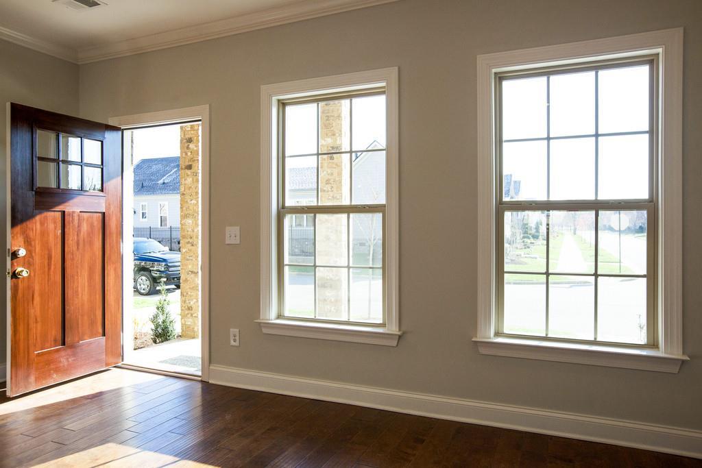 4325 Glassgow Road Spring Hill, TN 37174 - Photo 4 of 28 an empty room with wooden floor and windows