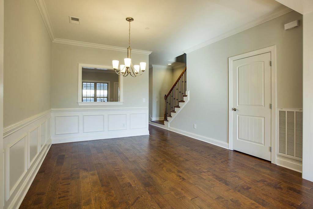 4325 Glassgow Road Spring Hill, TN 37174 - Photo 7 of 28 an empty room with wooden floor chandelier and windows