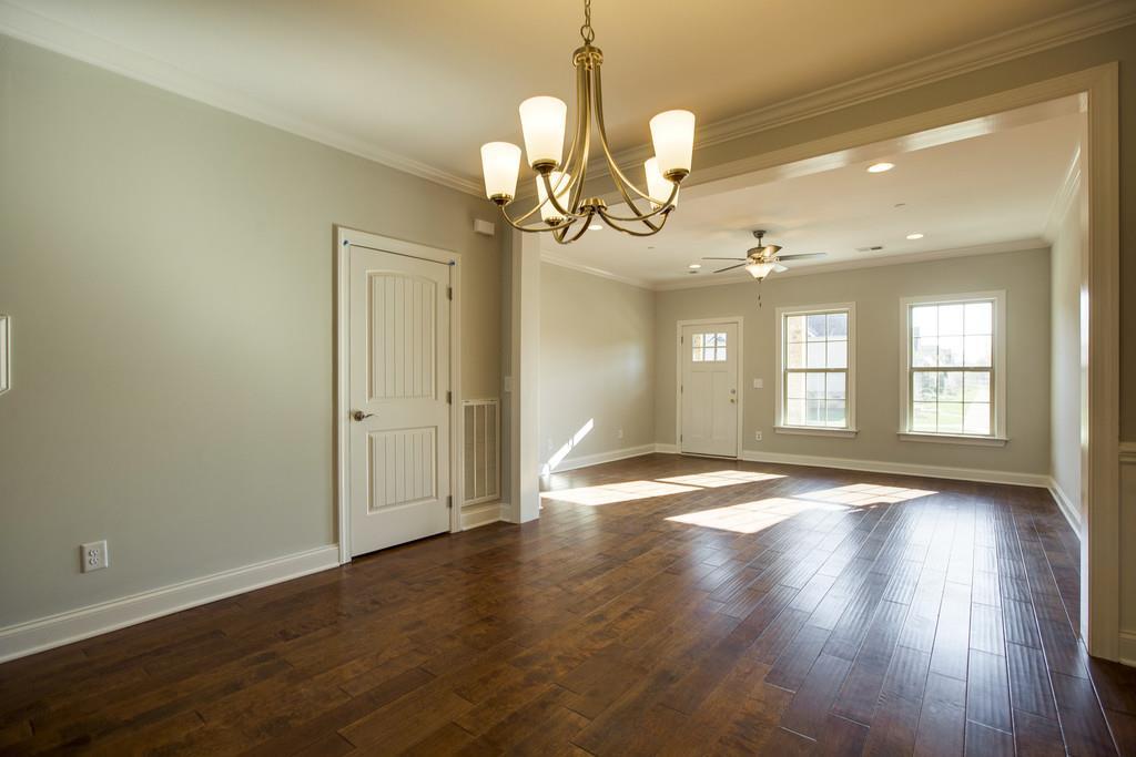 4325 Glassgow Road Spring Hill, TN 37174 - Photo 8 of 28 a view of an empty room with wooden floor and windows