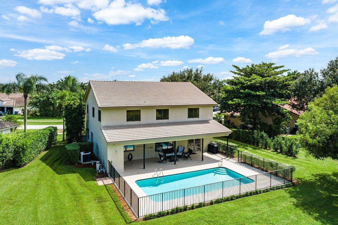 11842 Island Lakes Lane Boca Raton, FL 33498 - Photo 3 of 49 a aerial view of a house with swimming pool and yard with green space