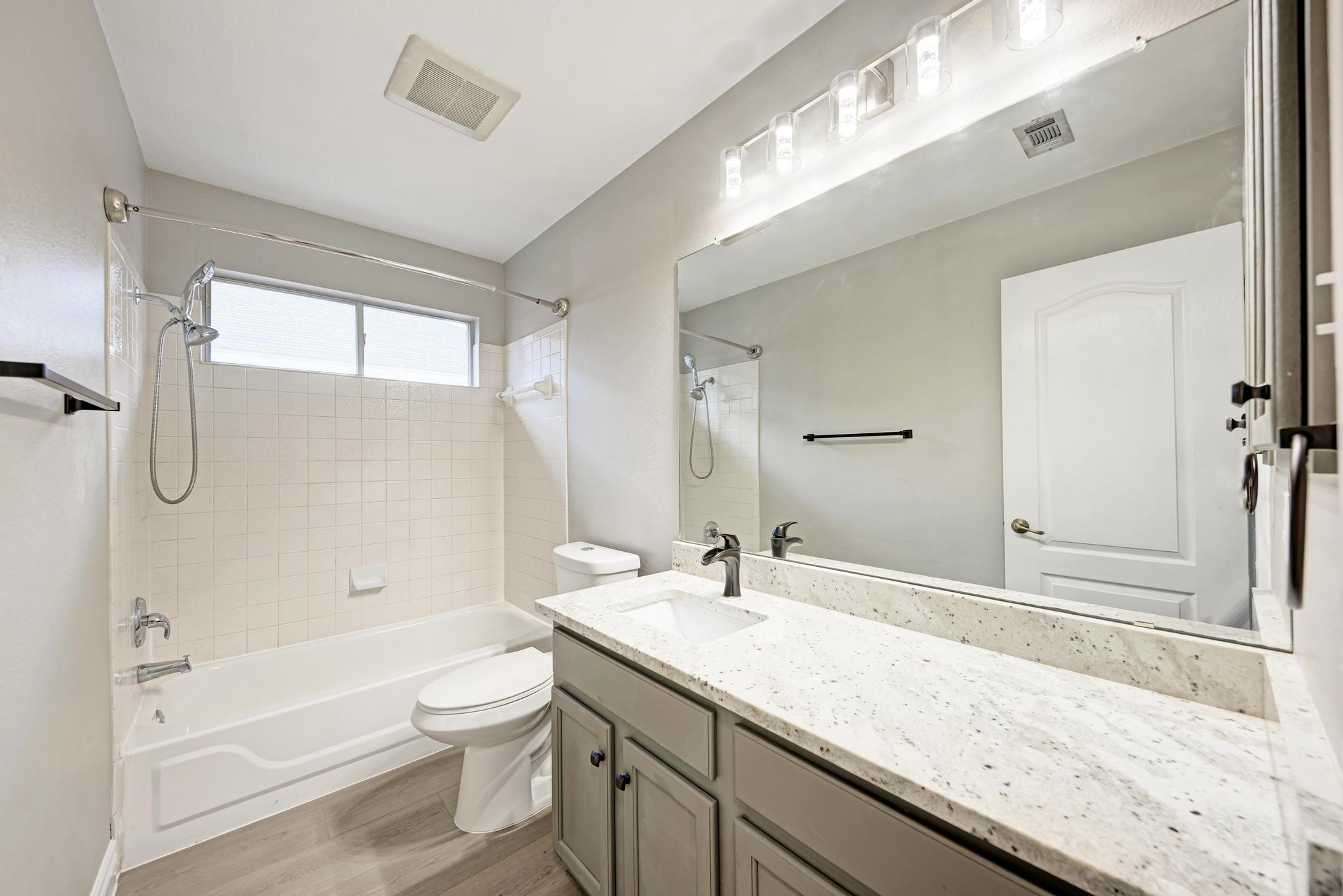 4408 Tello Path Austin, TX 78749 - Photo 27 of 38 Bathroom with shower / washtub combination, wood finished floors, and vanity