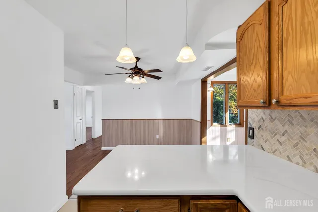 a view of kitchen and living room with a large window