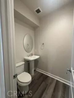 a bathroom with a sink toilet and a mirror