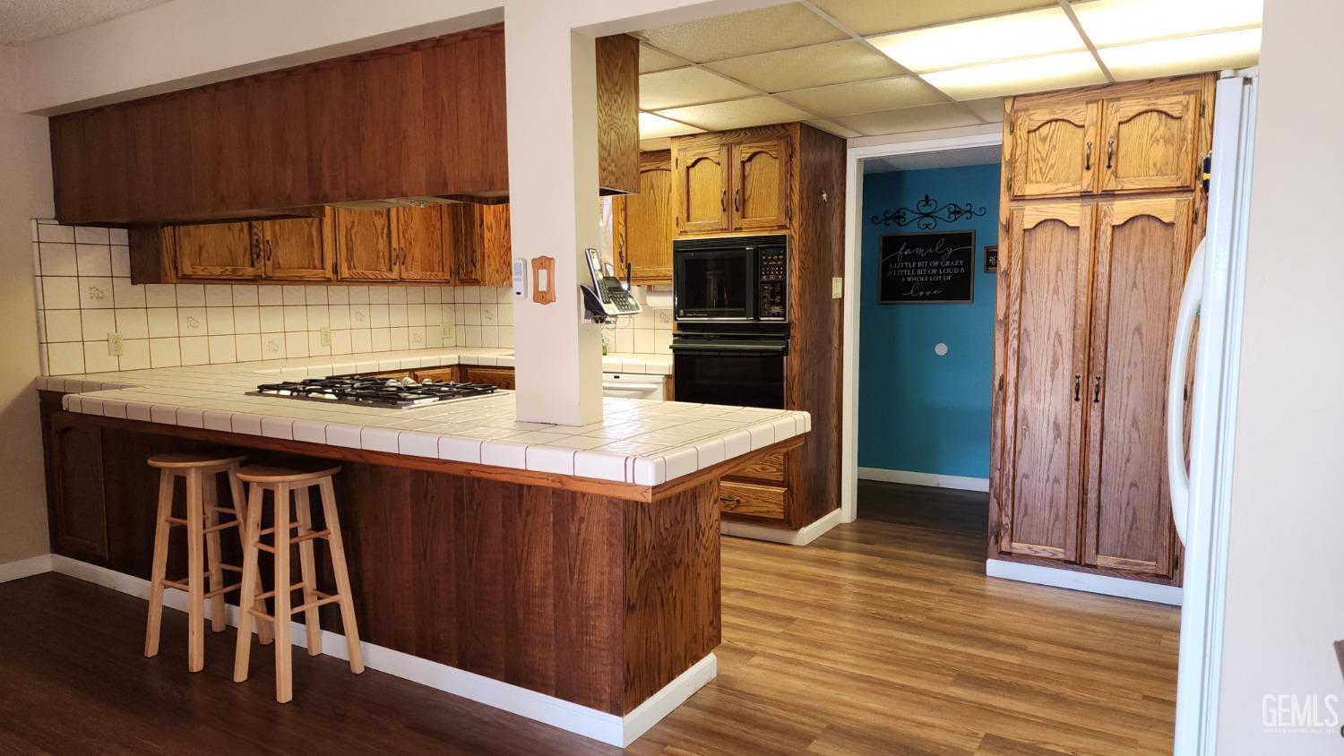 Undisclosed Address Bakersfield, CA 93306 - Photo 14 of 20 a kitchen with stainless steel appliances granite countertop a stove a refrigerator and a wooden cabinets