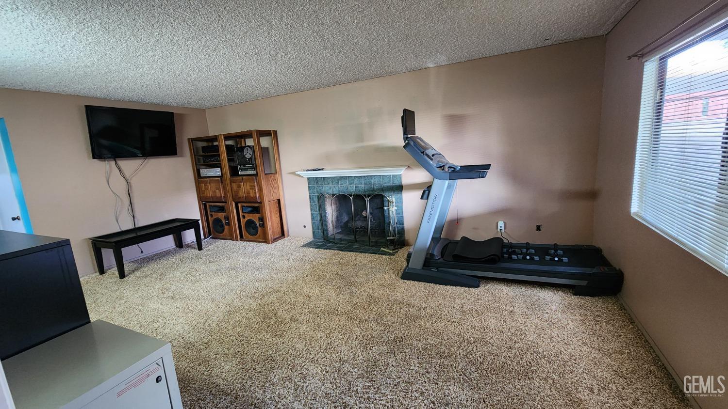 Undisclosed Address Bakersfield, CA 93306 - Photo 15 of 20 a bedroom with furniture and a fireplace