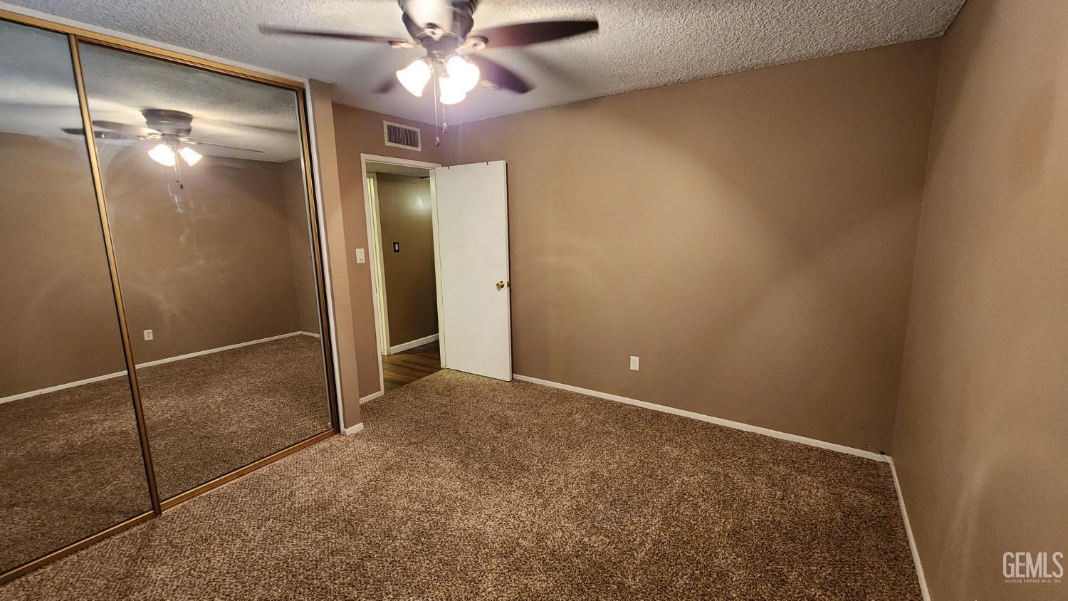 Undisclosed Address Bakersfield, CA 93306 - Photo 18 of 20 a view of an empty room with a fan