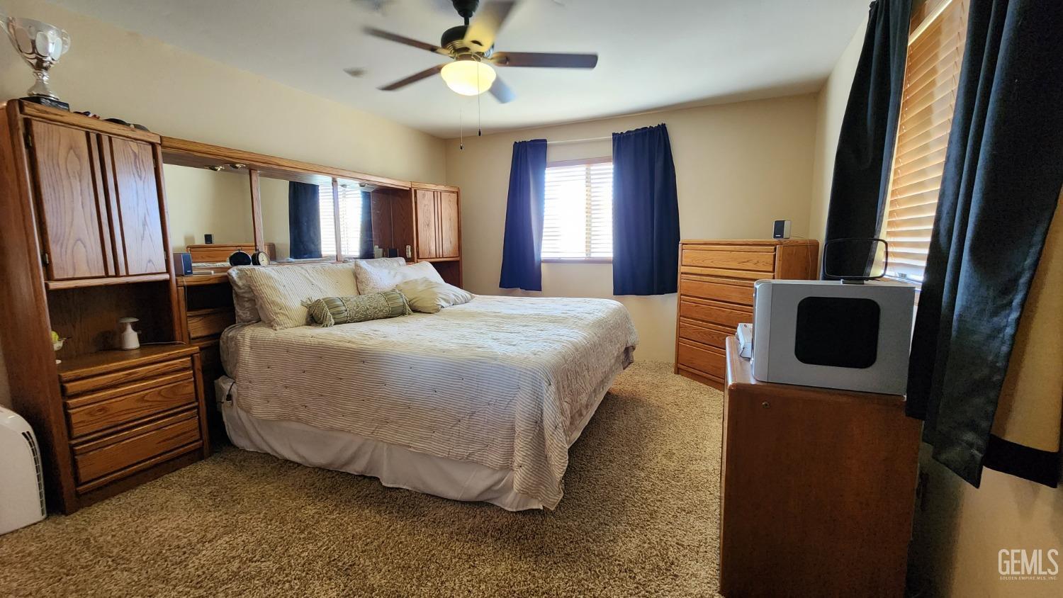 Undisclosed Address Bakersfield, CA 93306 - Photo 4 of 20 a bedroom with a bed dresser and a window