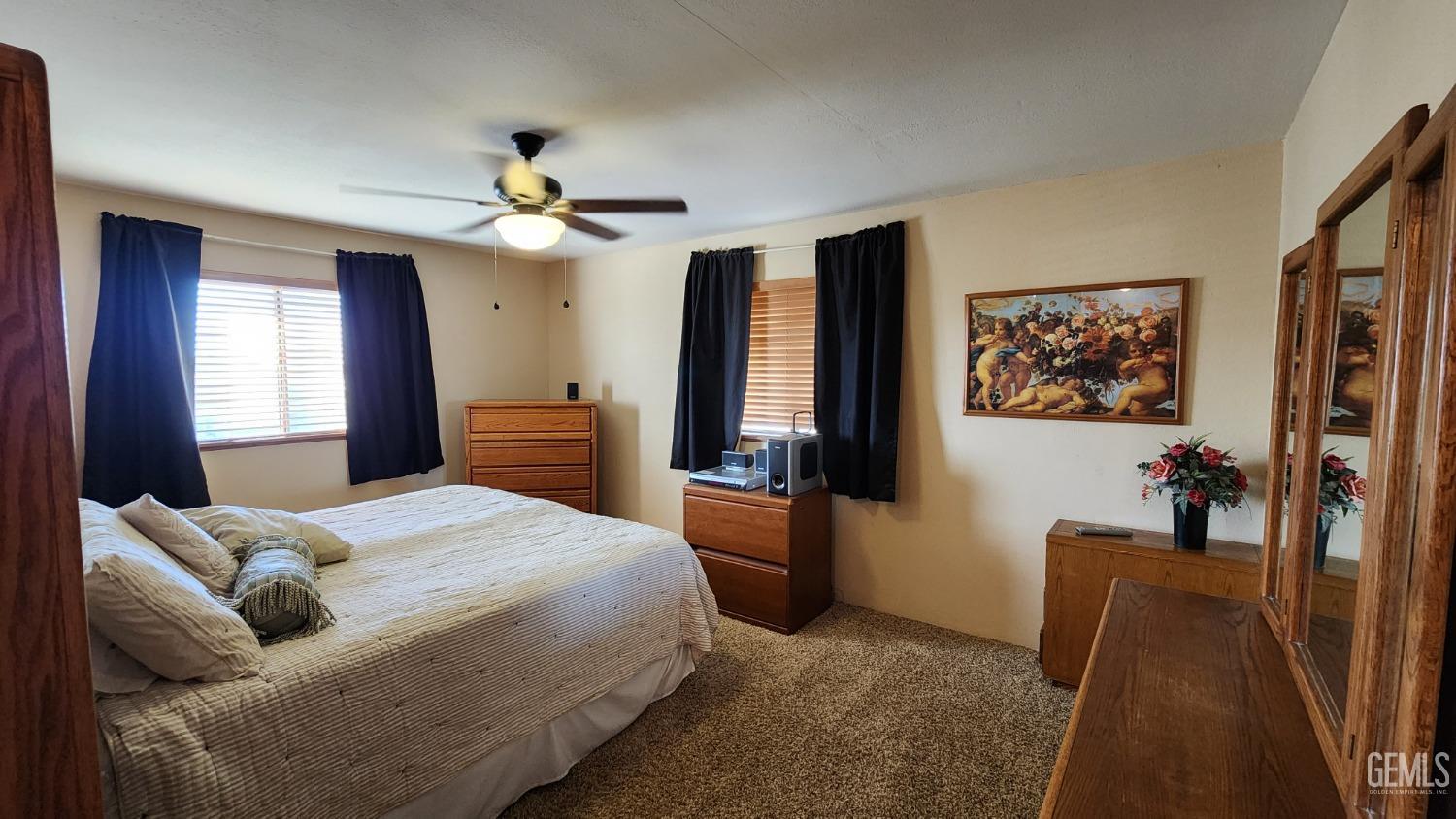 Undisclosed Address Bakersfield, CA 93306 - Photo 5 of 20 a bedroom with a bed and a chandelier