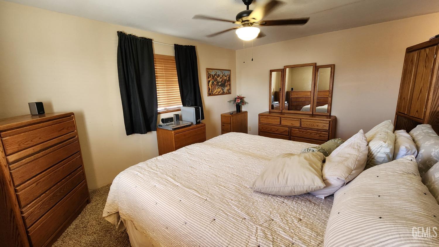 Undisclosed Address Bakersfield, CA 93306 - Photo 6 of 20 a bedroom with a bed and wooden floor