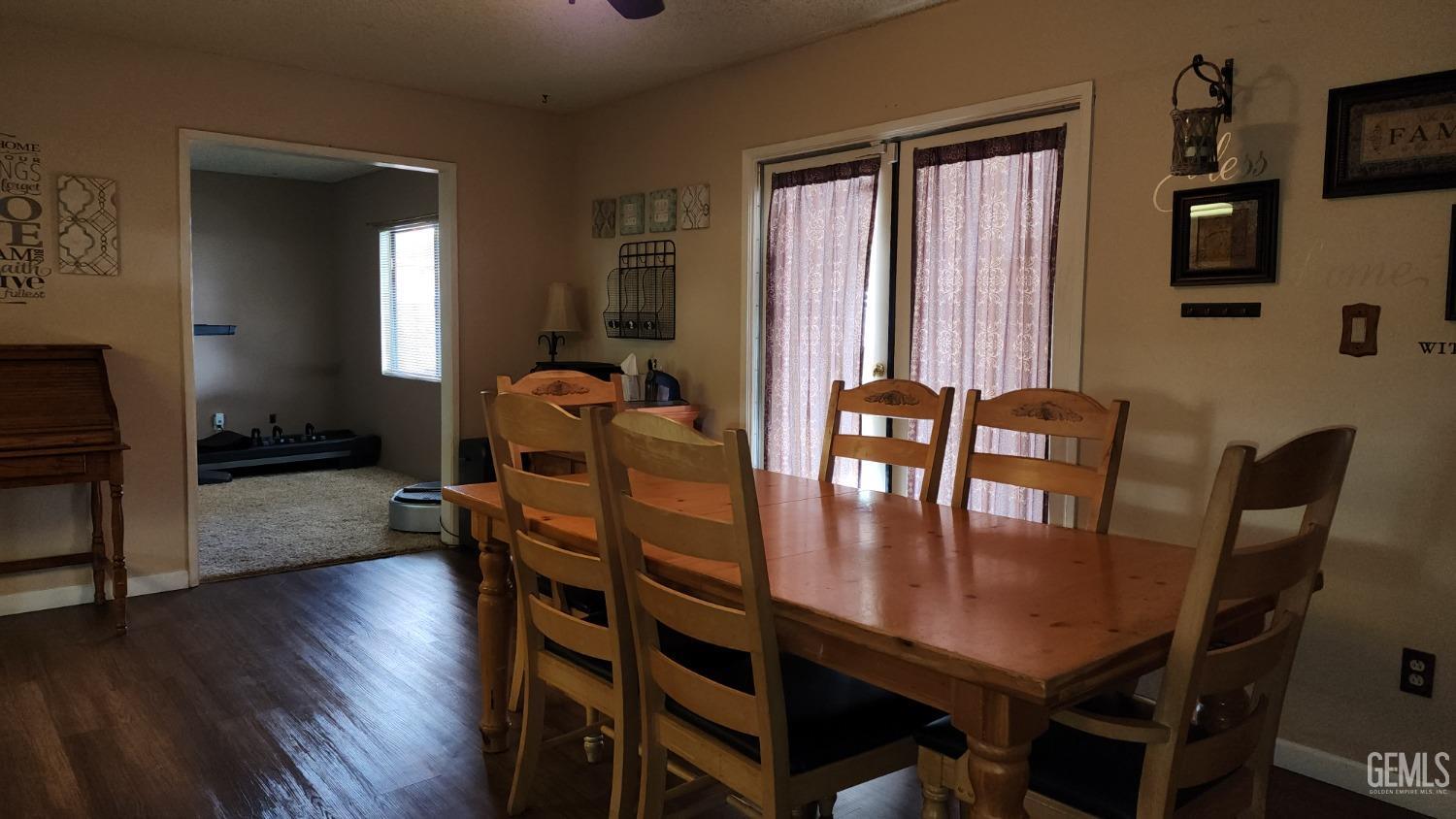 Undisclosed Address Bakersfield, CA 93306 - Photo 9 of 20 a dining room with furniture and wooden floor