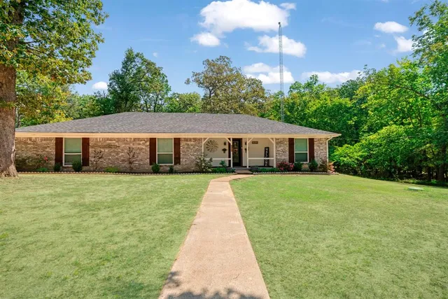 a front view of a house with a garden and porch