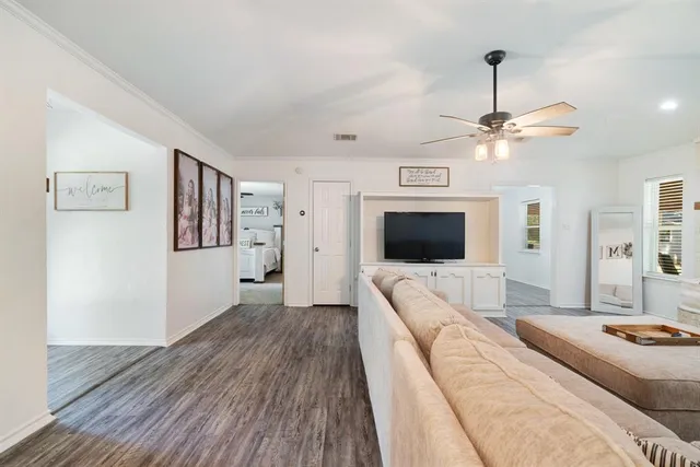 a spacious bedroom with a bed and a flat screen tv