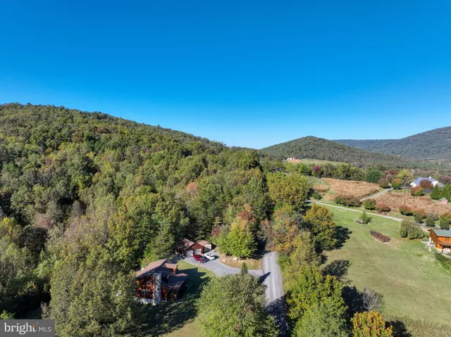 an aerial view of residential house and sandy dunes
