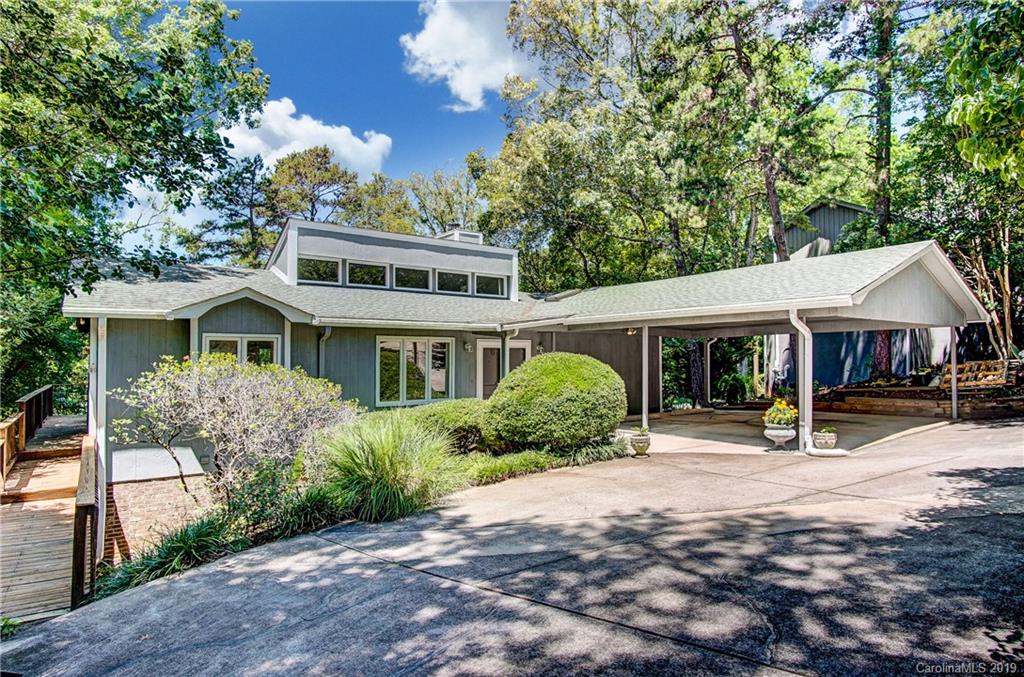 31002 Executive Point Tega Cay, SC 29708 - Photo 1 of 28 a front view of a house with a yard and potted plants