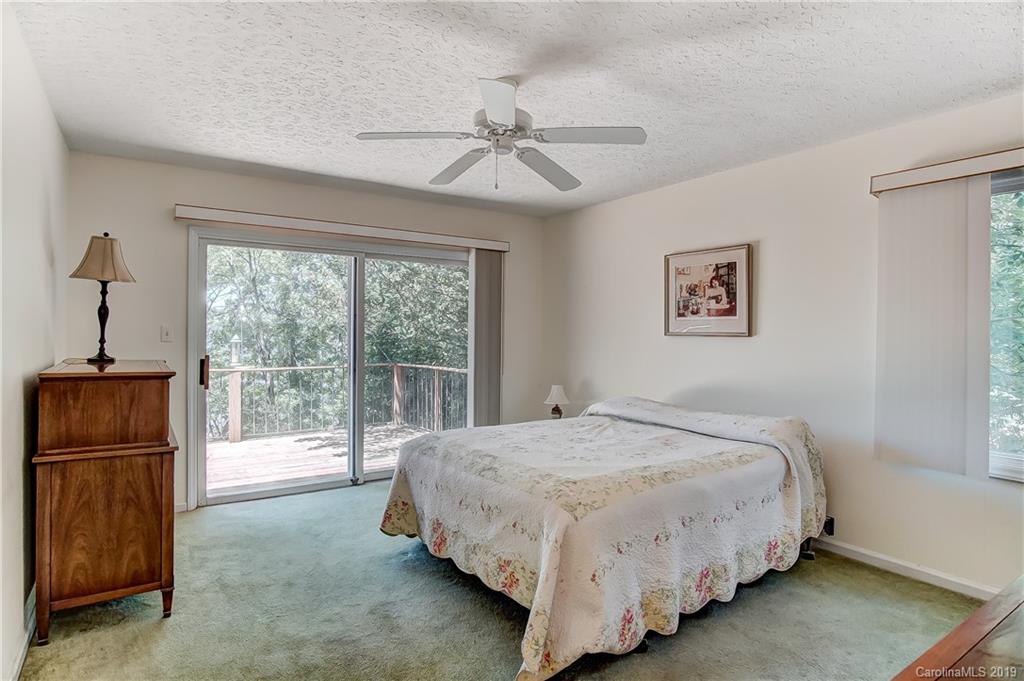 31002 Executive Point Tega Cay, SC 29708 - Photo 14 of 28 a bedroom with a bed and a window