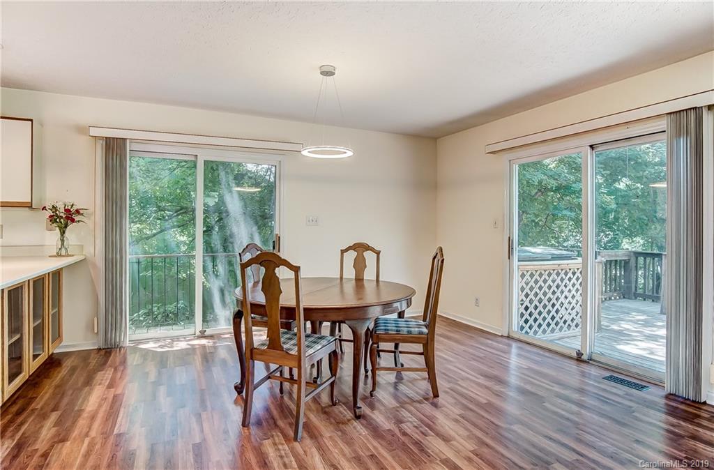 31002 Executive Point Tega Cay, SC 29708 - Photo 9 of 28 a view of a dining room with furniture window and wooden floor