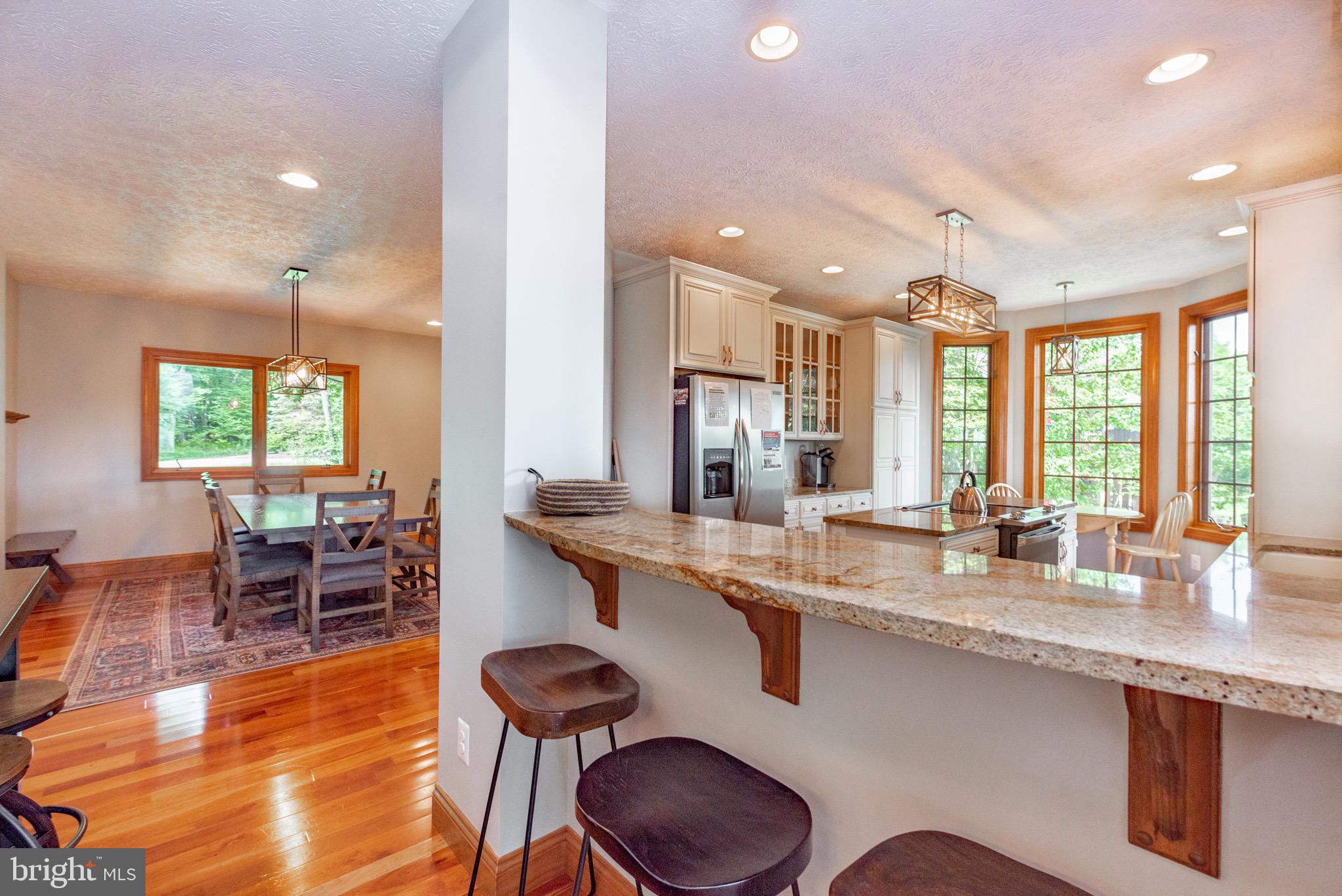 38 Parkside Court North McHenry, MD 21541 - Photo 12 of 60 a kitchen with stainless steel appliances granite countertop a table chairs stove and sink