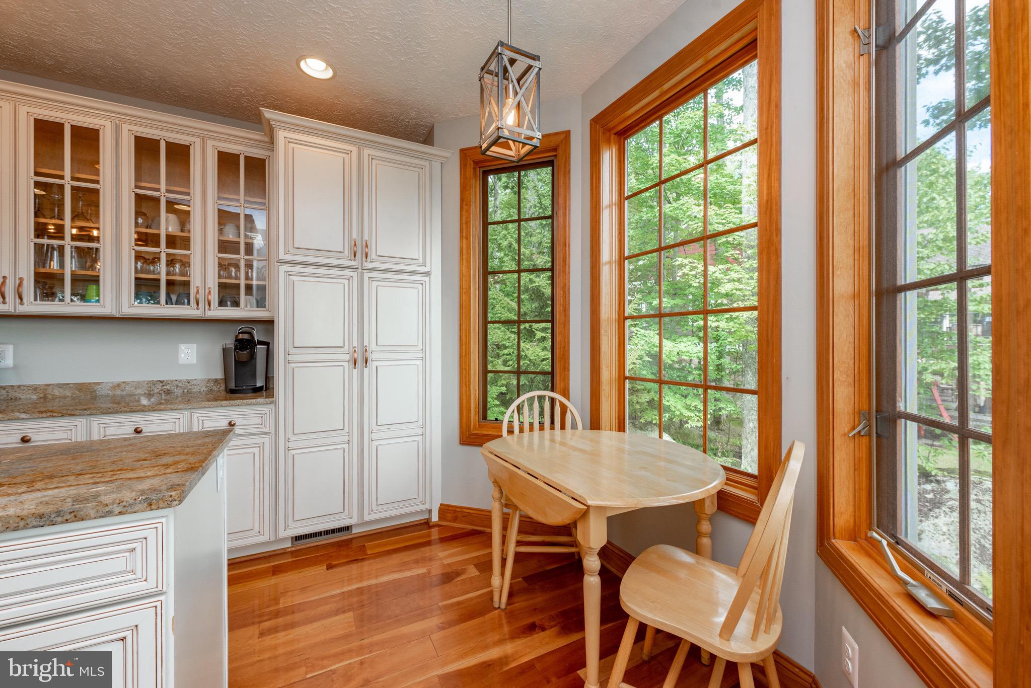 38 Parkside Court North McHenry, MD 21541 - Photo 15 of 60 a view of a dining room with furniture large windows and wooden floor