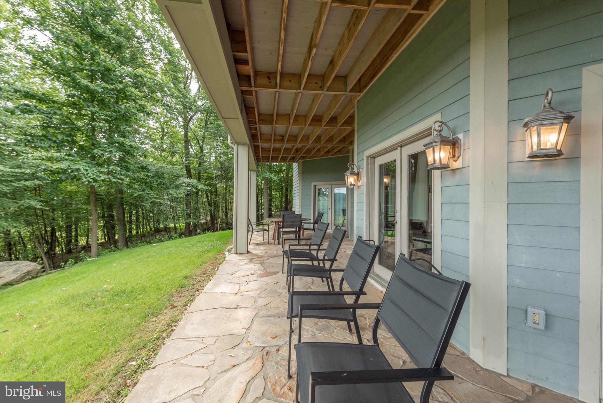 38 Parkside Court North McHenry, MD 21541 - Photo 53 of 60 a view of a patio with a table chairs and a backyard
