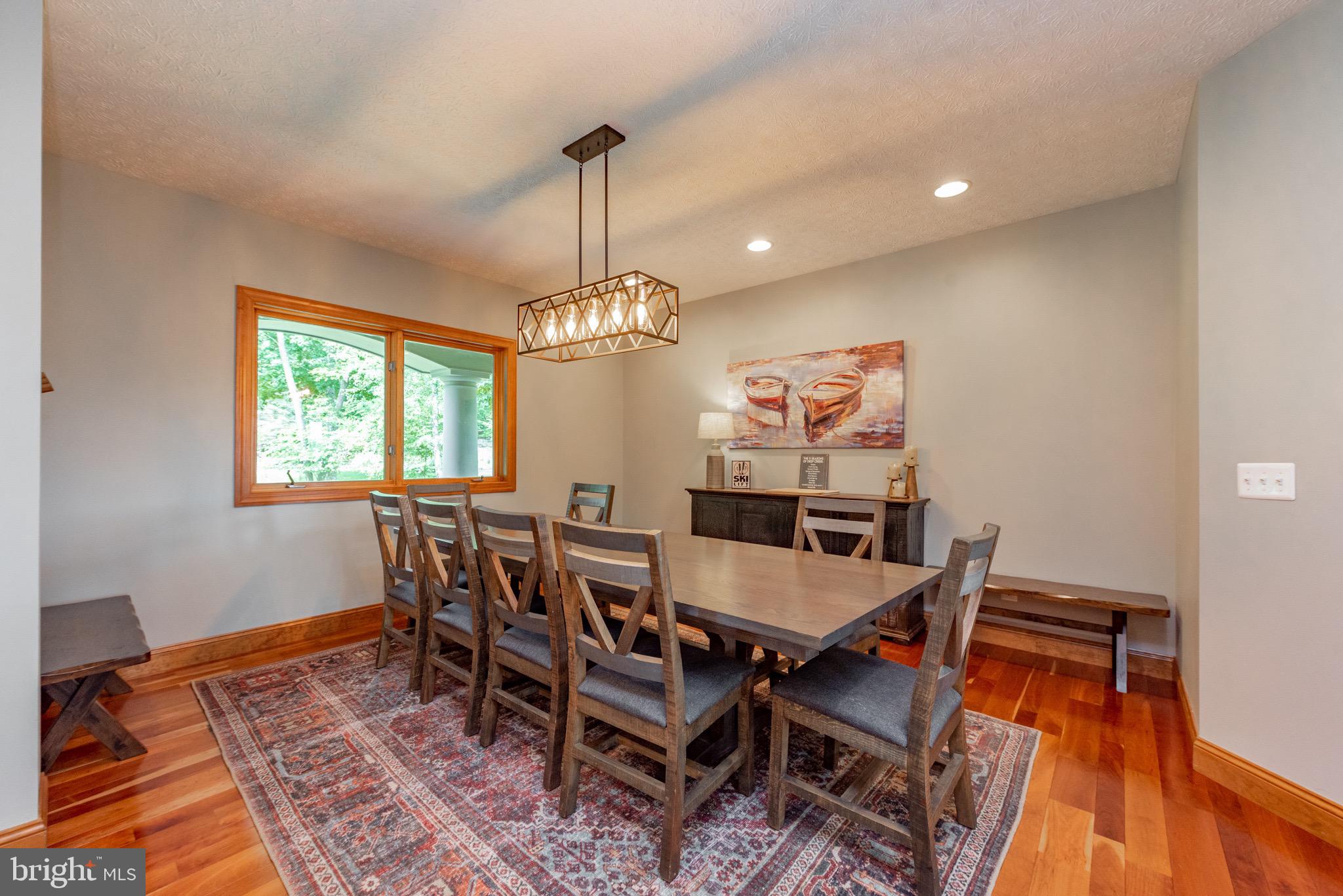 38 Parkside Court North McHenry, MD 21541 - Photo 9 of 60 a view of a dining room with furniture a chandelier and wooden floor
