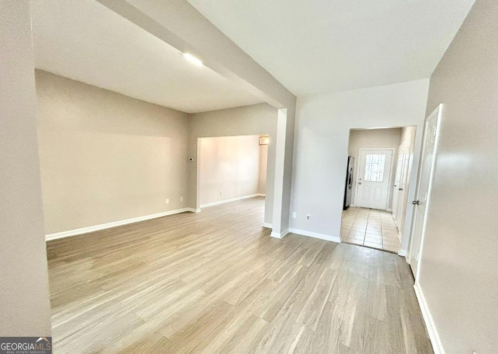 1017 Wheel House Lane, Unit A Monroe, GA 30655 - Photo 2 of 9 a view of an empty room with wooden floor