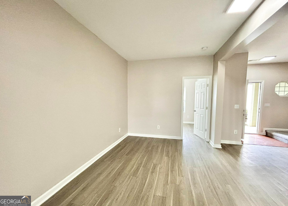 1017 Wheel House Lane, Unit A Monroe, GA 30655 - Photo 3 of 9 a view of a room with wooden floor and brick walls