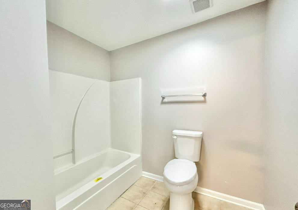 1017 Wheel House Lane, Unit A Monroe, GA 30655 - Photo 8 of 9 a bathroom with a toilet and a bathtub