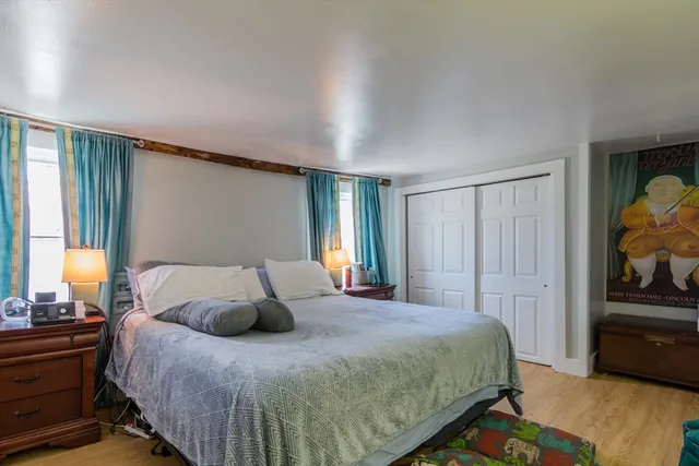 a bedroom with a bed and window