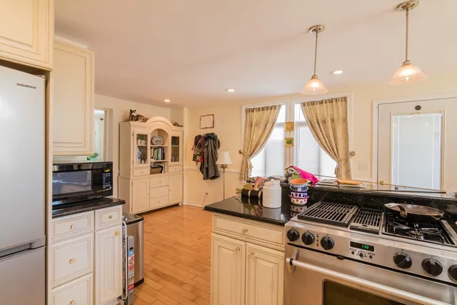 a kitchen with counter top space cabinets and appliances