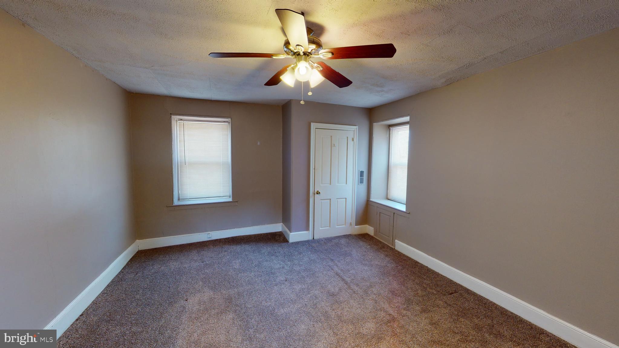 211 Front Street, Unit 3 Bordentown, NJ 08505 - Photo 3 of 9 a view of room with window and ceiling fan