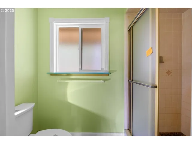 a bathroom with a toilet and a shower