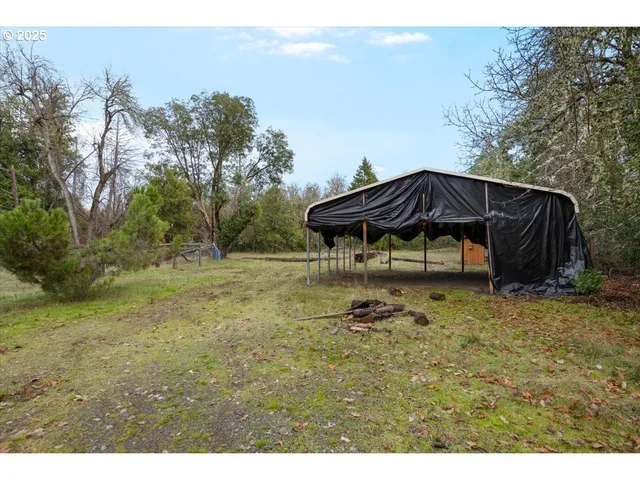 a backyard of a house with table and chairs