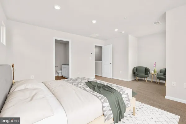 a spacious bedroom with a bed and window