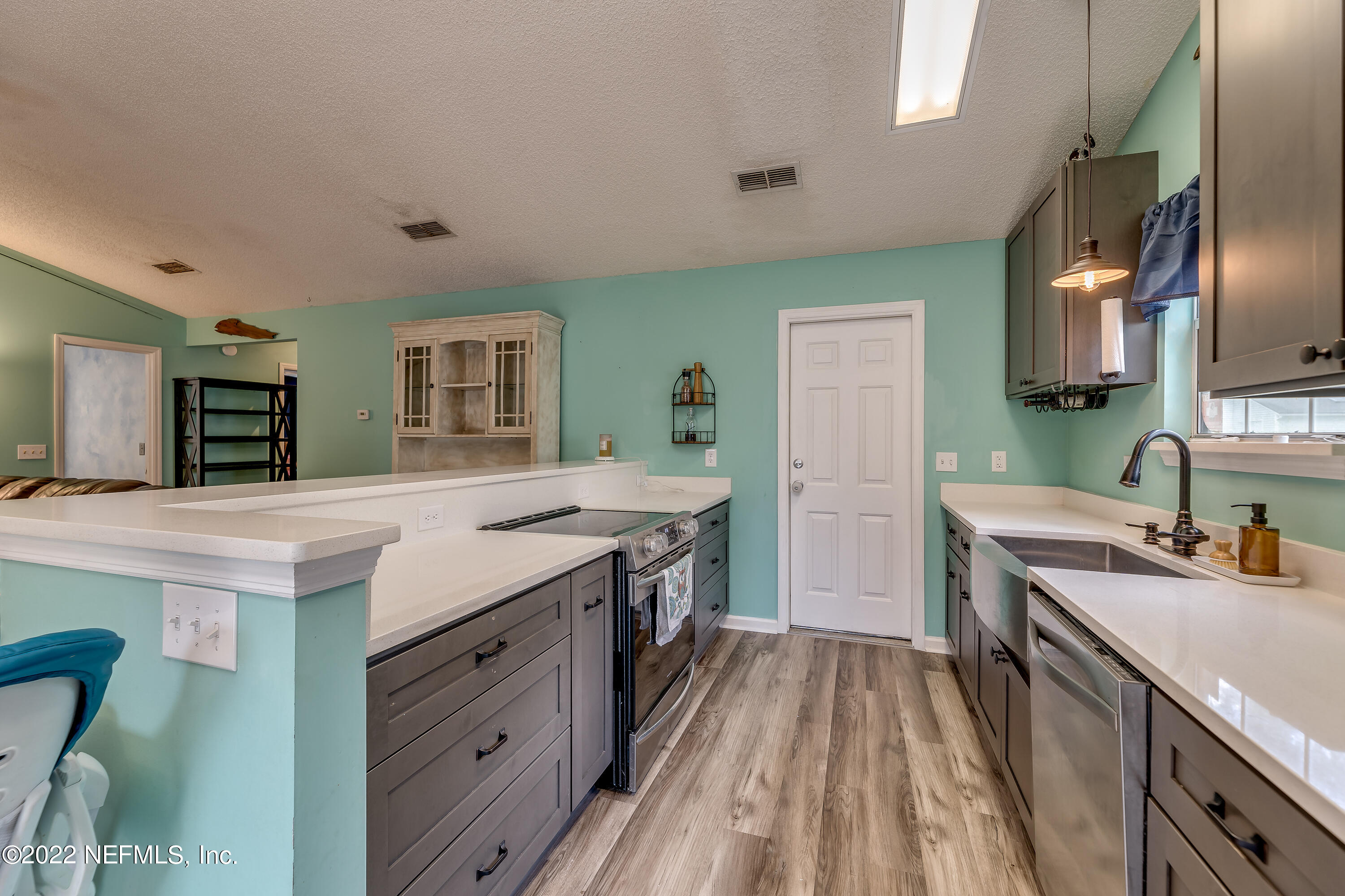 12743 Beaubien Road Jacksonville, FL 32258 - Photo 12 of 28 a kitchen with granite countertop a sink stove and refrigerator