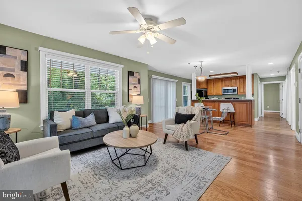 a living room with furniture and view of kitchen