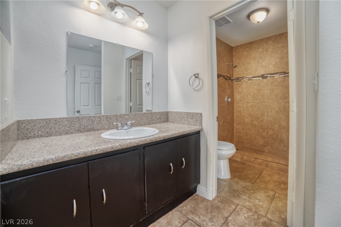 3556 Ruth Drive Las Vegas, NV 89121 - Photo 11 of 21 A compact bathroom featuring a sink vanity with ample storage, providing practical elegance.